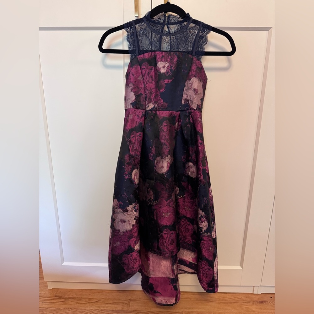Beautiful formal hi-lo dress with lace accents at neck